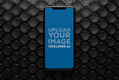 Mockup of an iPhone 11 Pro Max over a Patterned Surface