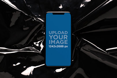 Mockup of an iPhone 11 Pro Max over Black Rubber Fabric 