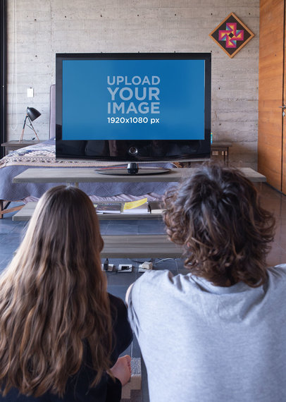 Mockup of Two Friends Watching TV Together 
