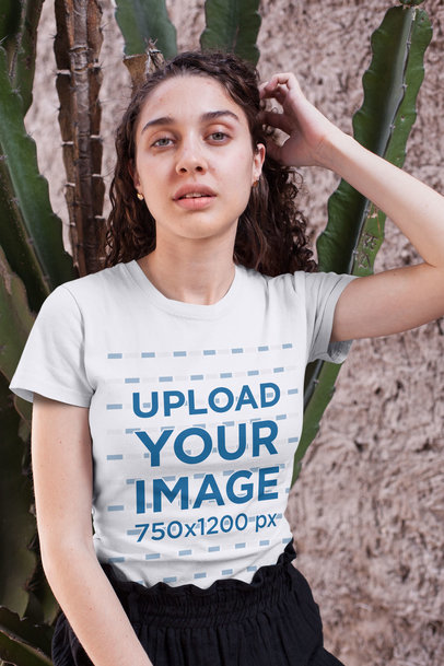 Camping T-Shirt Mockup of a Curly-Haired Woman Sitting by a Cactus 