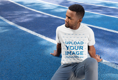 T-Shirt Mockup of a Man Sitting on a Blue Track 25924