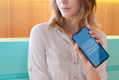 iPhone 11 Pro Max Mockup Featuring a Blonde Woman in a Colorful Room