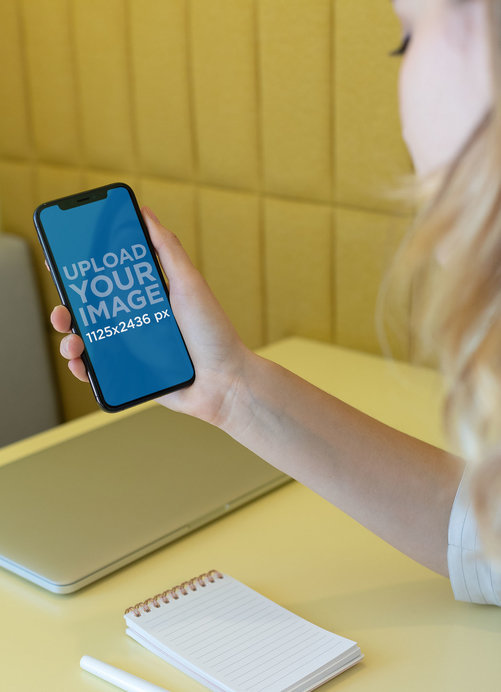 Mockup of a Blonde Woman Using Her iPhone 11 Pro 