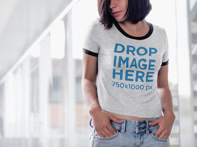 T-Shirt Mockup of a Young Woman Standing in a Hallway