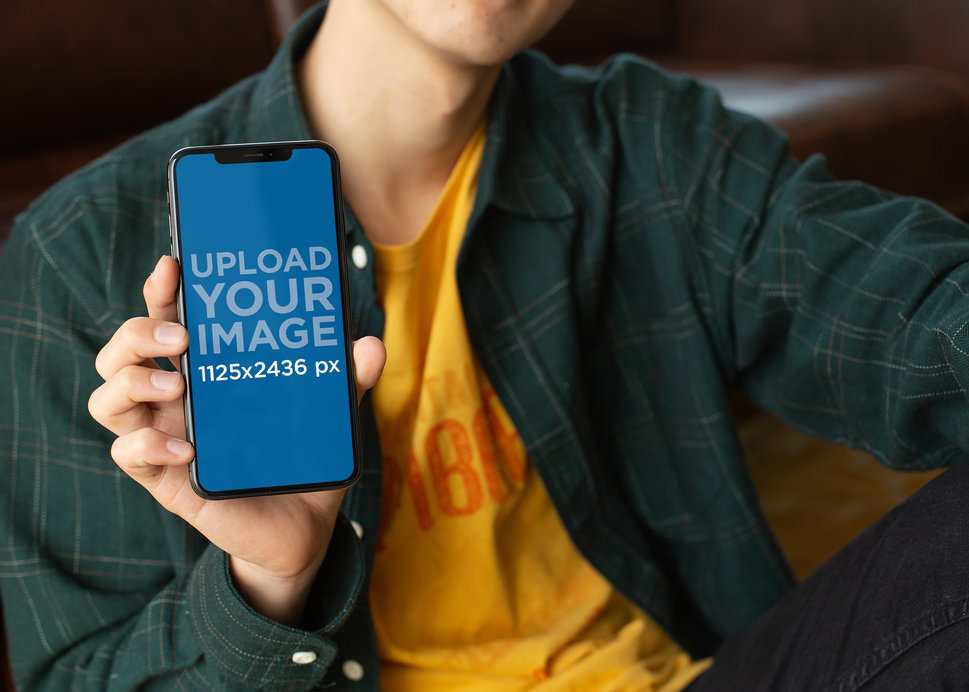 Mockup of a Slim Man Holding an iPhone 11 Pro