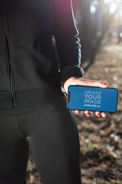 iPhone 11 Pro Max Featuring a Fitness Woman Showing Her Screen at Sunrise