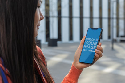 Mockup of a Dark Haired Girl Using Her iPhone XS 25762