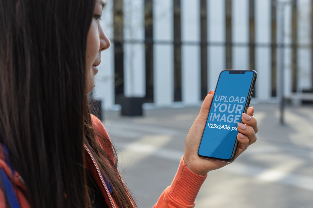 Mockup of a Dark Haired Woman Using Her iPhone 11 Pro