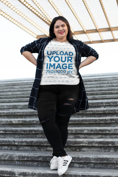 Mockup of a Joyful Woman Wearing a Plus Size T-Shirt Under Lightbulbs