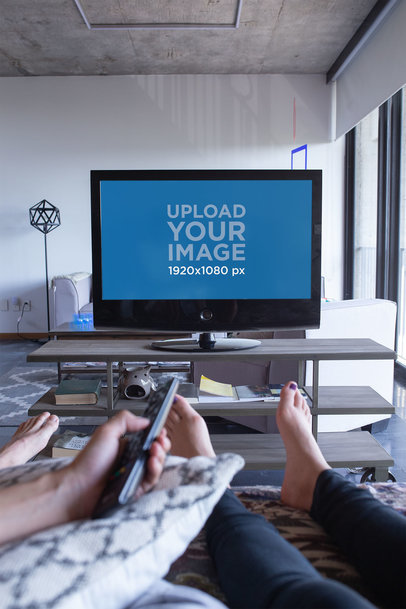 Smart Tv Mockup Featuring a Barefoot Couple Chilling in a Modern Living Room
