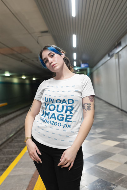 Plus Size T-Shirt Mockup of a Blue-Haired Woman Posing at a Subway Station