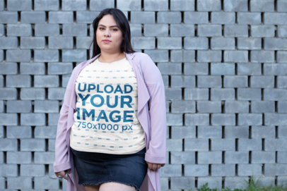 Plus Size T-Shirt Mockup of a Woman in a Short Skirt by a Concrete-Tiles Wall