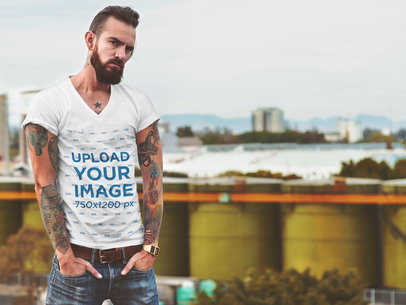 T-Shirt Mockup of a Tattooed Hipster Man at a Rooftop 