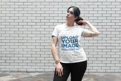 Plus Size Tee Mockup of a Tattooed Girl Fixing Her Hair in Front of a Dirty Wall 25481