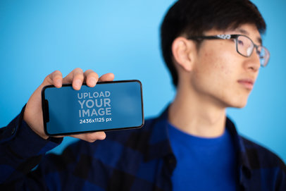 iPhone 11 Pro Mockup of a Man with Glasses Looking Away
