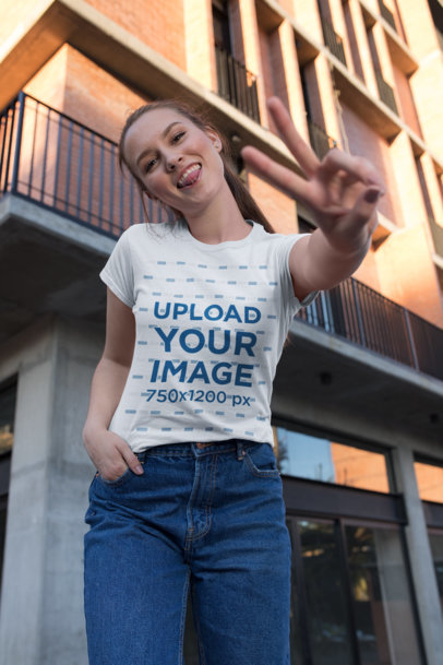 T-Shirt Mockup of a Woman Making the Peace Sign 