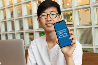 iPhone 11 Pro Max Mockup Featuring a Geek Man with Glasses