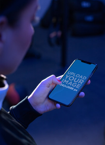 iPhone 11 Pro Max Mockup Of a Fitness Woman Checking Her Screen at Night