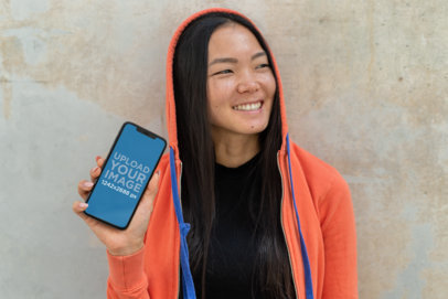 iPhone 11 Pro Max Mockup Featuring a Smiling Woman with a Hoodie
