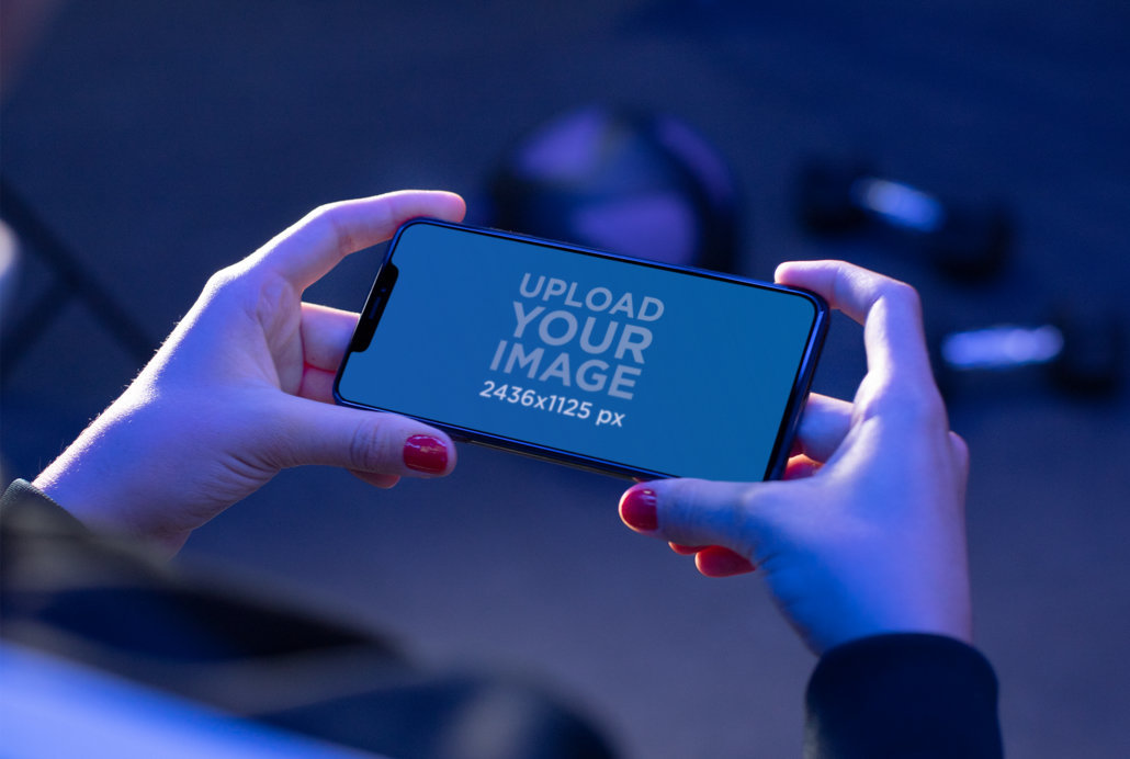 Over the Shoulder View Mockup of a Fitness Woman Checking Her iPhone 11 Pro Max