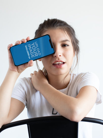 Mockup of a Girl Covering One Eye with Her iPhone XS Max 25826