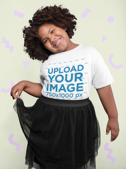 Tee Mockup of a Cheerful Girl with Afro Hair Surrounded by Cut Out Paper Shapes