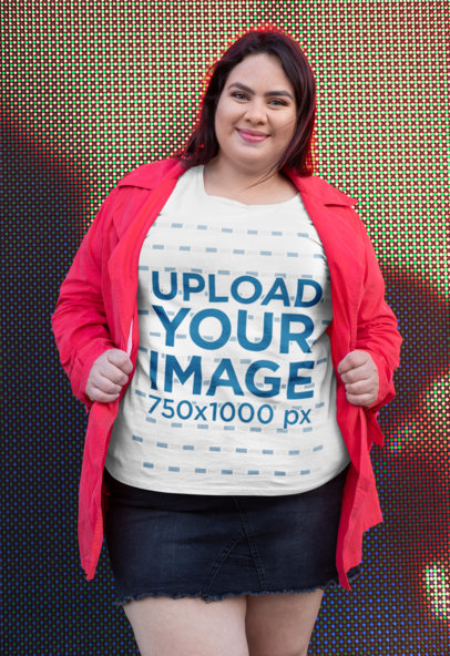 Plus Size Tee Mockup Featuring a Happy Woman in Front of a Led-Lights Screen