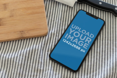 iPhone XS Max Mockup Surrounded by a Knife and a Cutting Board 25891