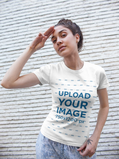 Tee Mockup of a Woman with a Hair Bun Making a Salute Sign