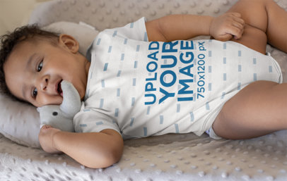 Onesie Mockup of a Baby Boy Lying on a Soft Cushion