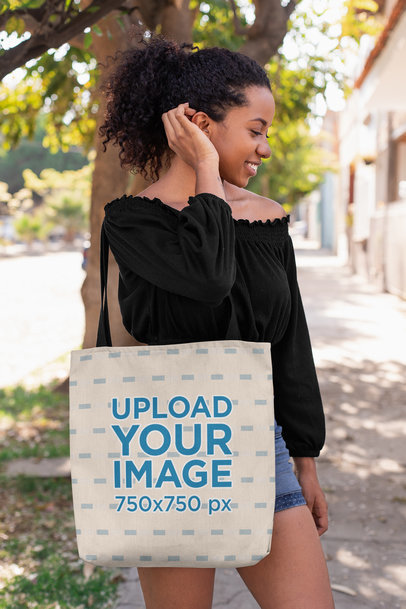 Tote Bag Mockup of a Woman Fixing Her Hair on a Street