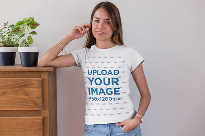 Tee Mockup of a Blonde Woman Leaning over a Wooden Chest of Drawers 26347