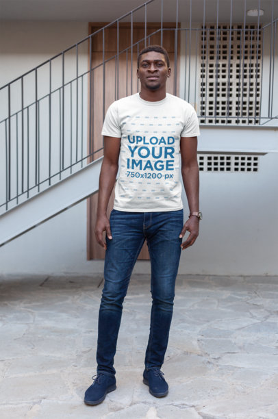 T-Shirt Mockup Featuring a Man Casually Standing by a Staircase