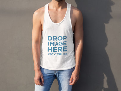 Tank Top Mockup of a Man in Front of a Concrete Wall