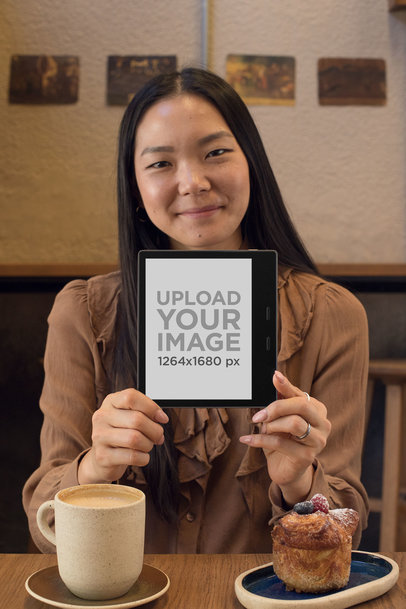 Mockup of a Pretty Girl Holding a Kindle in a Cafe 26023