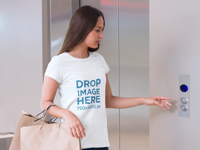 T-Shirt Mockup Featuring a Woman Waiting for an Elevator a7988