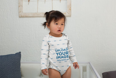 Sublimated Onesie Mockup of a Cute Baby Girl Standing Inside Her Crib