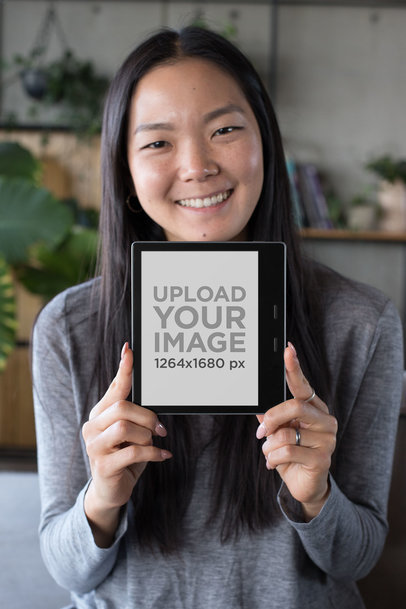 Kindle Oasis Mockup featuring a Smiling Woman with Freckles