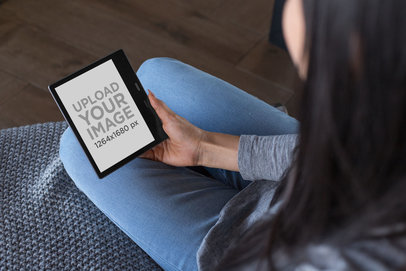 Over-The-Shoulder Mockup of a Woman Placing a Kindle Oasis on Her Lap 26028