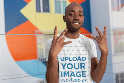 T-Shirt Mockup Featuring a Man Making Modern Hand Gestures