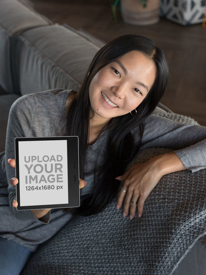Kindle Oasis Mockup of a Joyful Woman Leaning over a Sofa 26030