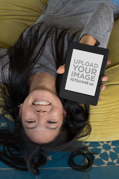 Upside-down Mockup of a Woman with Long Hair Showing Her Kindle Paperwhite