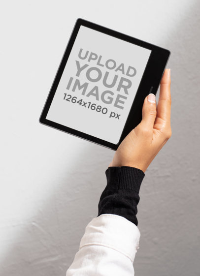 Mockup of a Kindle Oasis Being Held Against a Wall