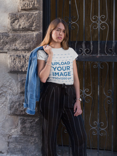 T-Shirt Mockup of a Blonde Woman Leaning on a Wall