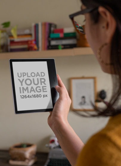 Mockup of a Woman Reading from Her Kindle Oasis in Her Studio 26073
