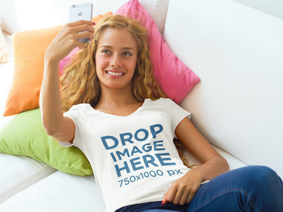T-Shirt Mockup Featuring a Young Woman Taking a Selfie 