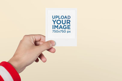 Mockup of a Polaroid Picture Frame Held by a Man with a Red Jacket 26178