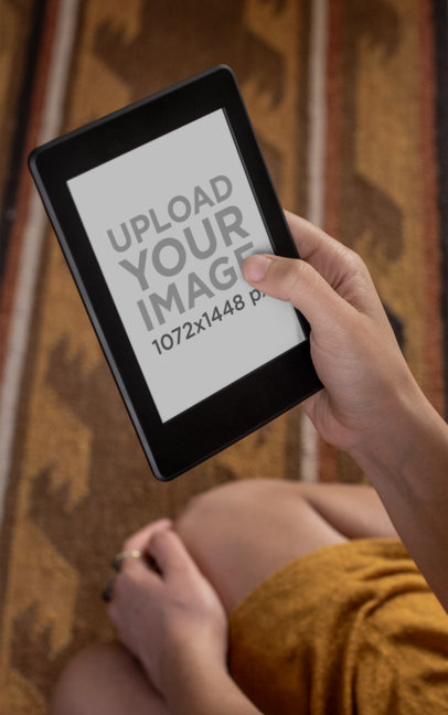 Over-The-Shoulder Mockup of a Woman Reading from Her Kindle Paperwhite