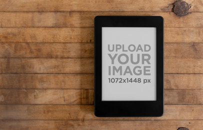 Mockup of a Kindle Paperwhite over a Wooden Surface