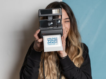 Polaroid Frame Mockup Featuring a Woman Taking a Picture with Her Instant Camera 26303